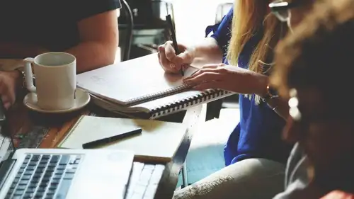 Paper statements and a pen laid out on a wooden desk